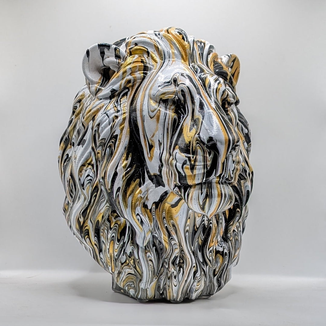 White, black and gold lion head ornament with flowing marbled paint