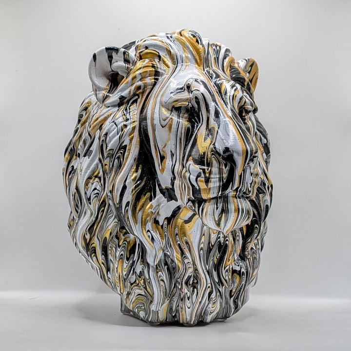 White, black and gold lion head ornament with flowing marbled paint