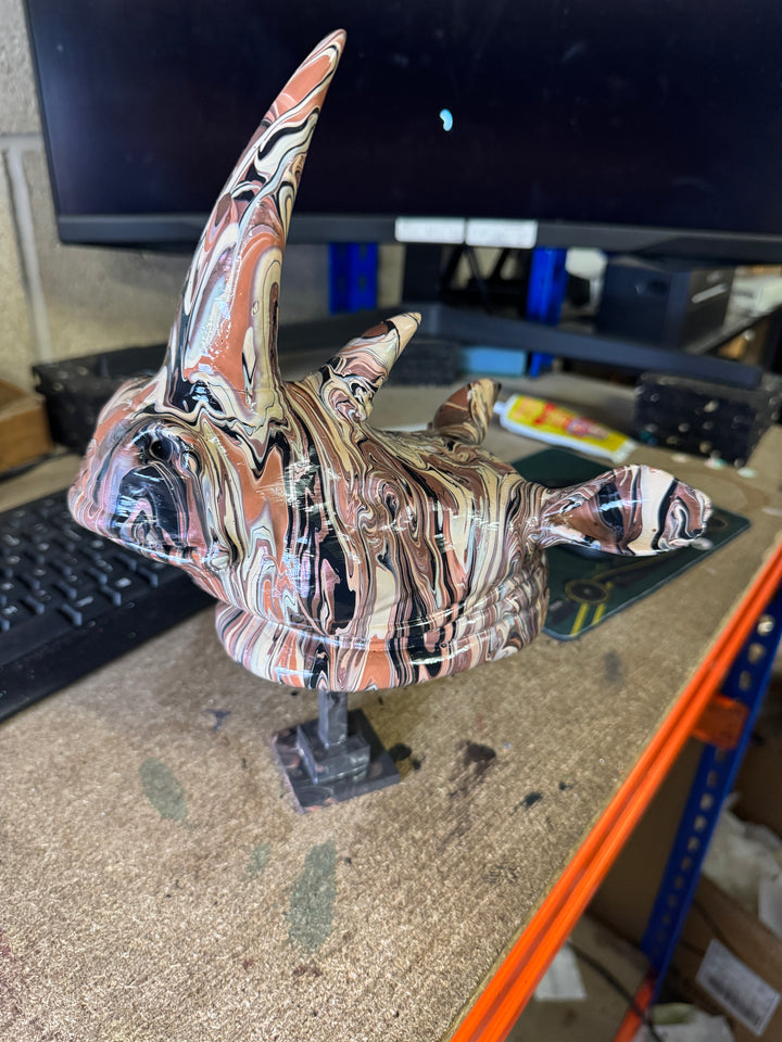 Hand-painted rhino head sculpture in brown, cream and black