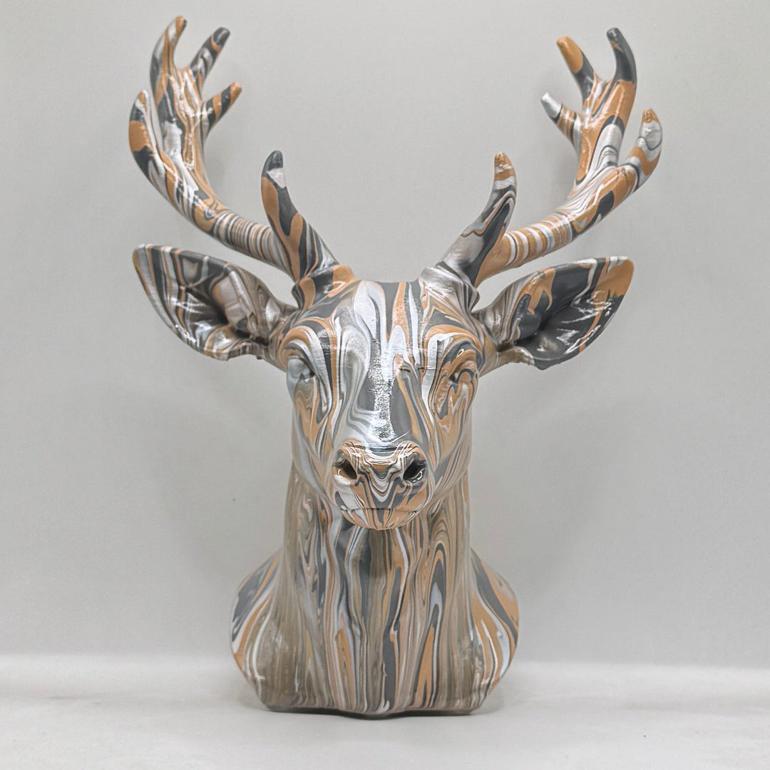 Front view of a hand-painted stag head ornament in bronze, silver and black